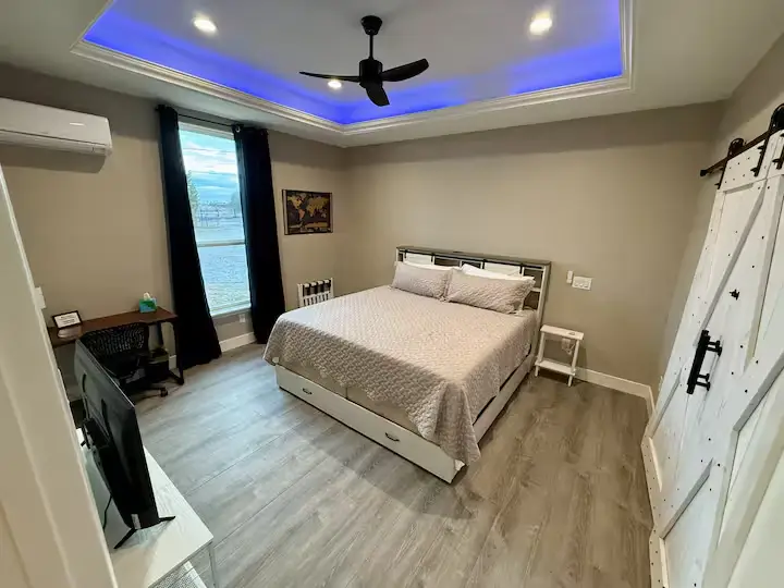 Bedroom with a large bed and a window with curtains