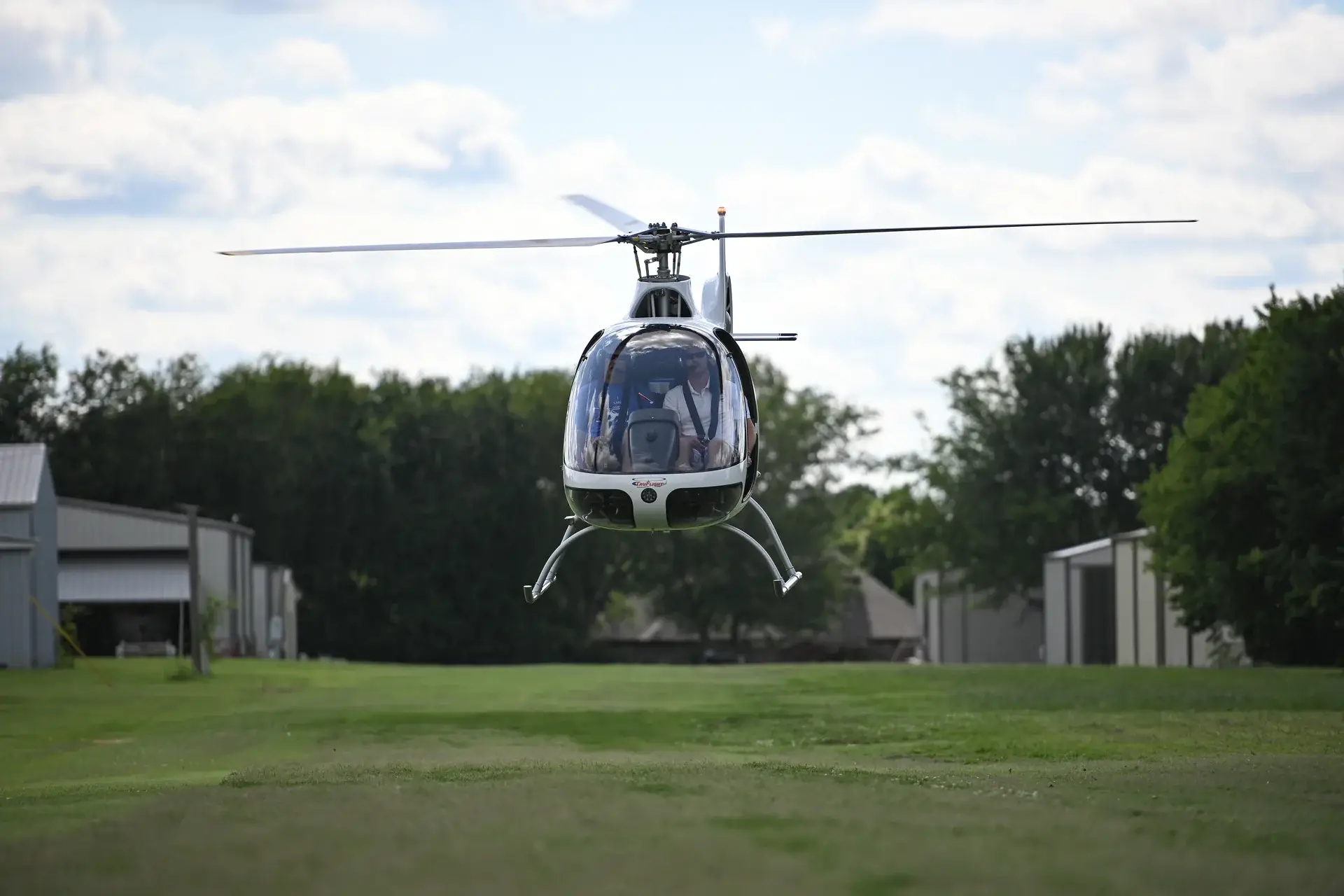 Student and instructor in TruFlight's hovering helicopter, front view