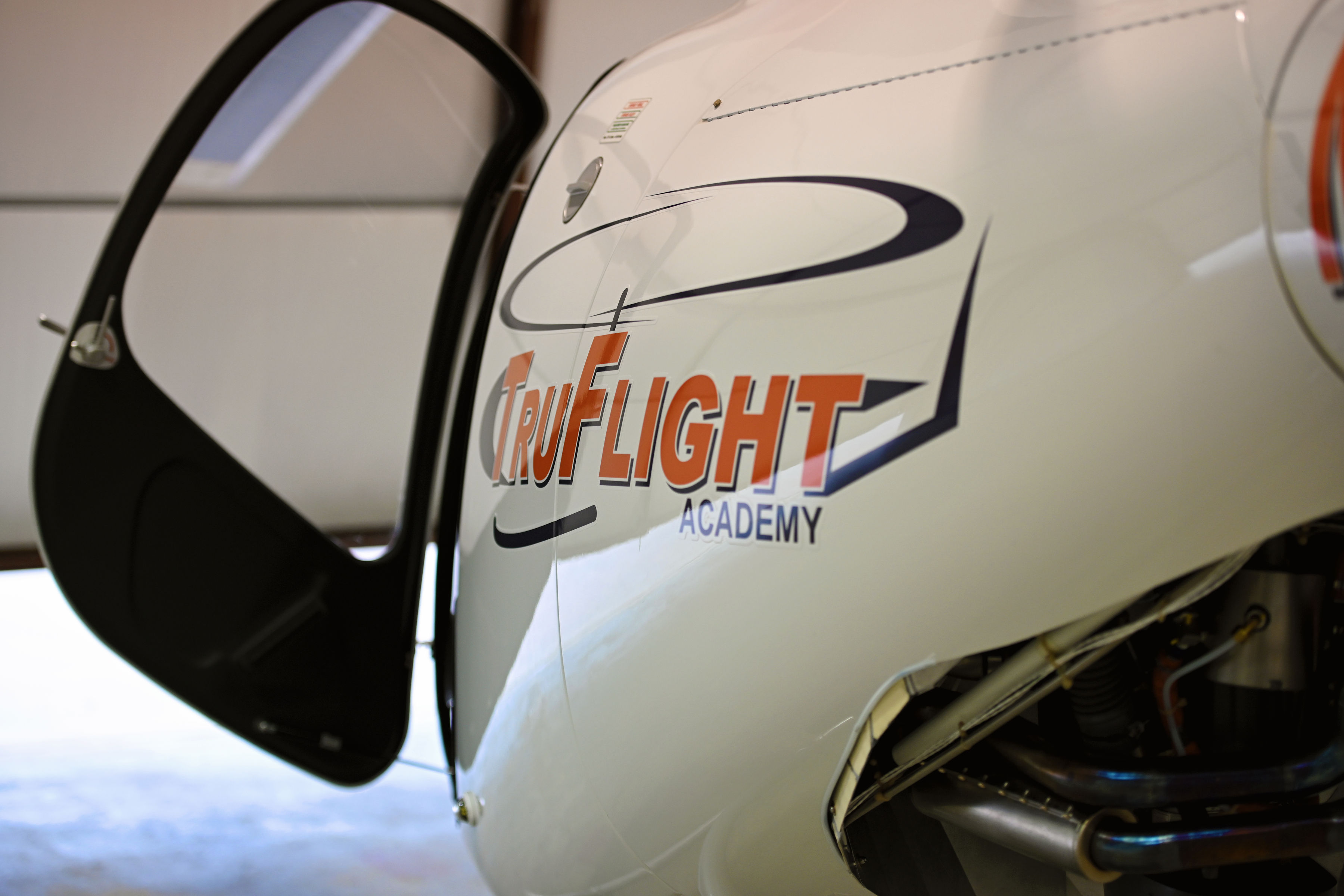 Open door and TruFlight Academy logo on a Guimbal Cabri G2 helicopter