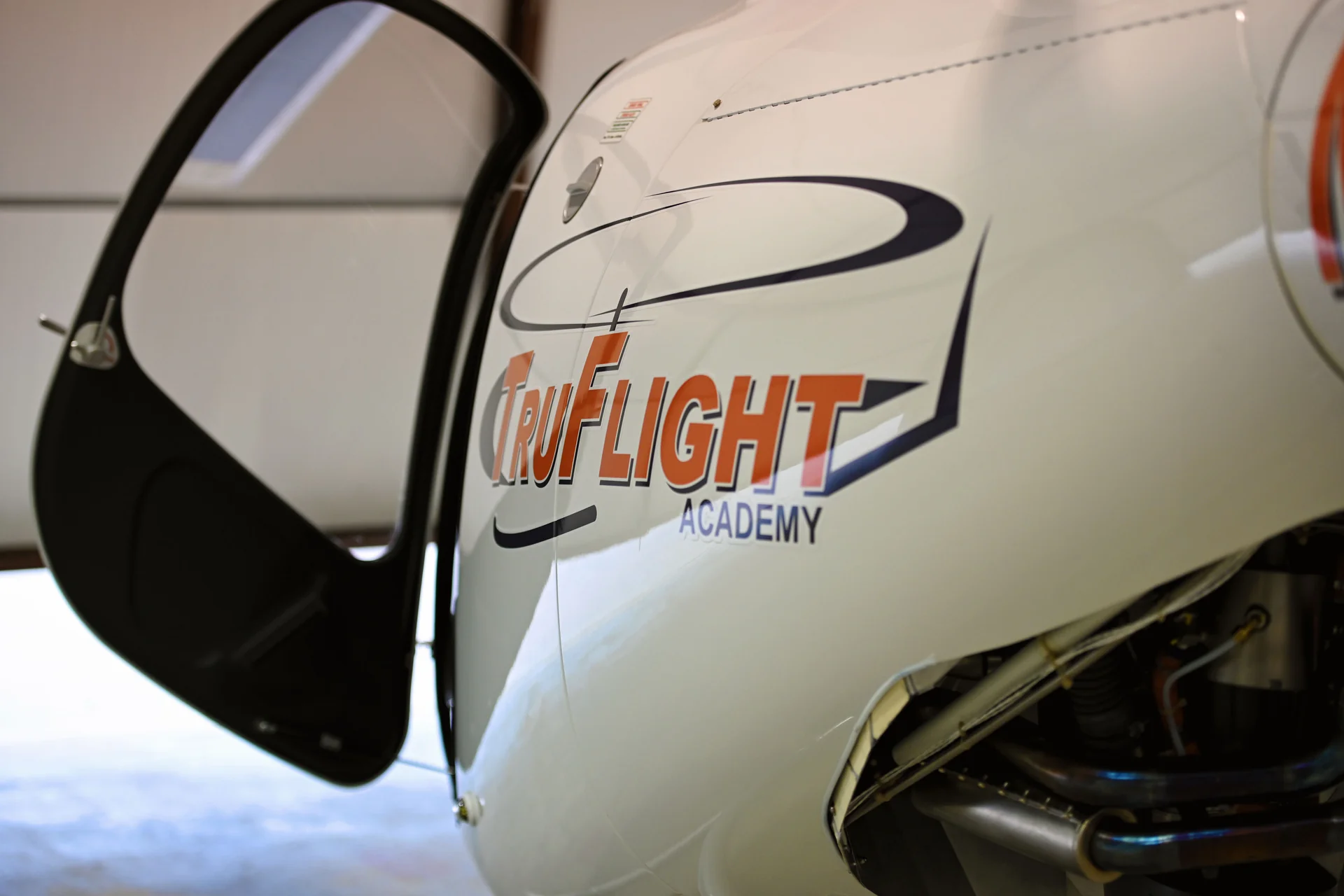 Open door and TruFlight Academy logo on a Guimbal Cabri G2 helicopter
