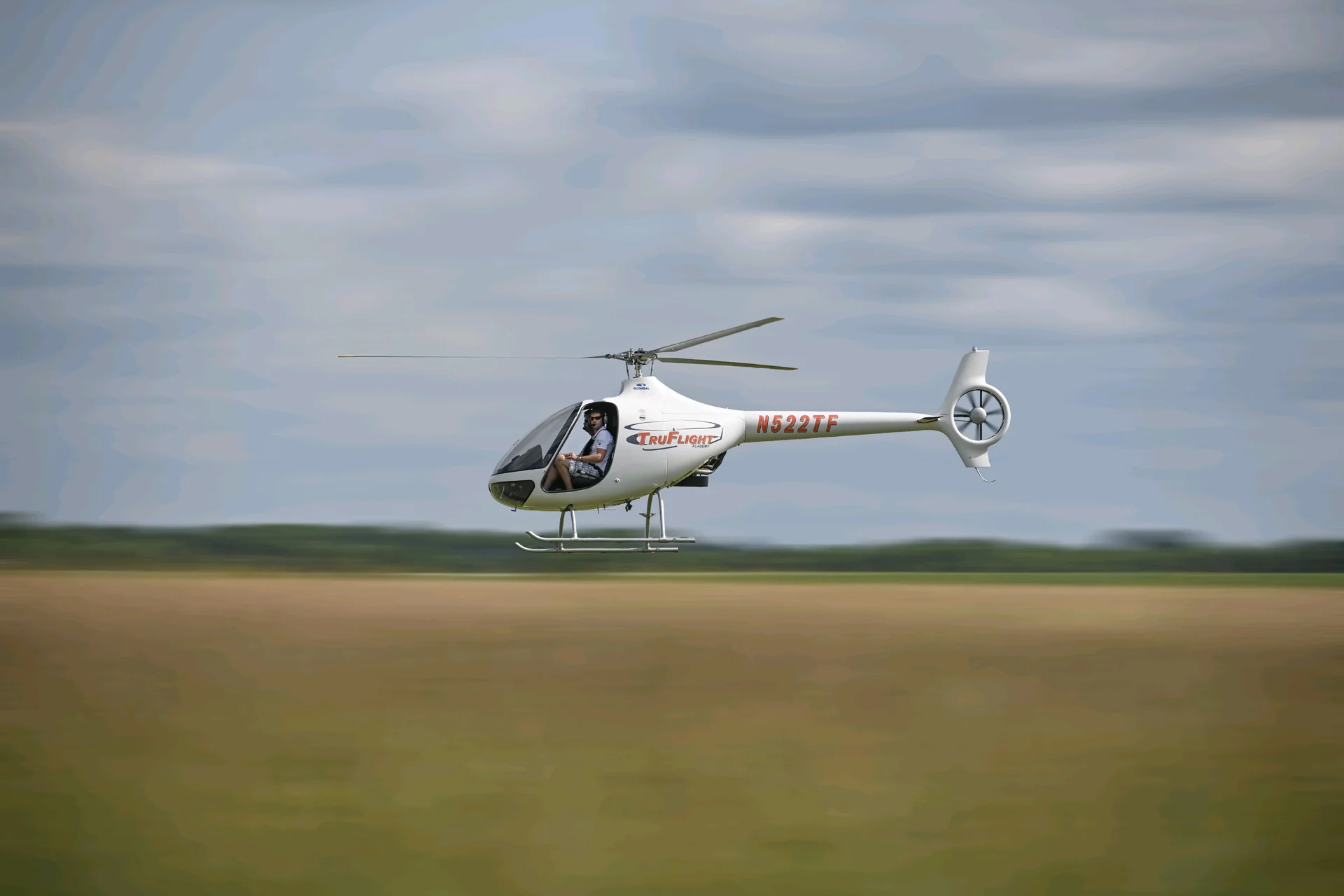 TruFlight Academy Guimbal Cabri G2 flying low over a field